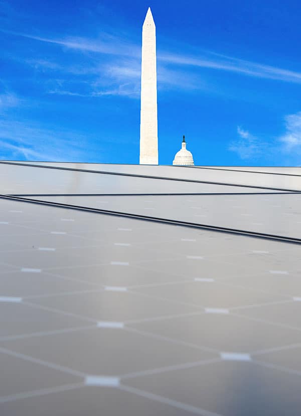 solar array with Washington DC monument in the background