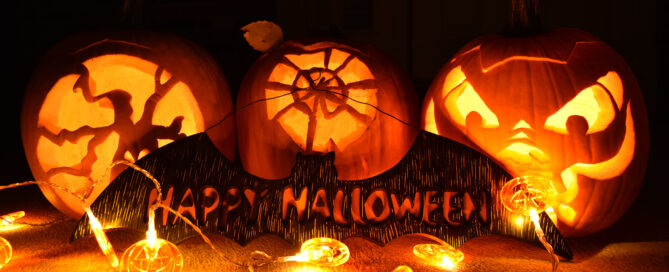 District Energy sustainable holiday lighting with carved Halloween pumpkins glowing with LED string lights, showcasing eco-friendly seasonal décor.